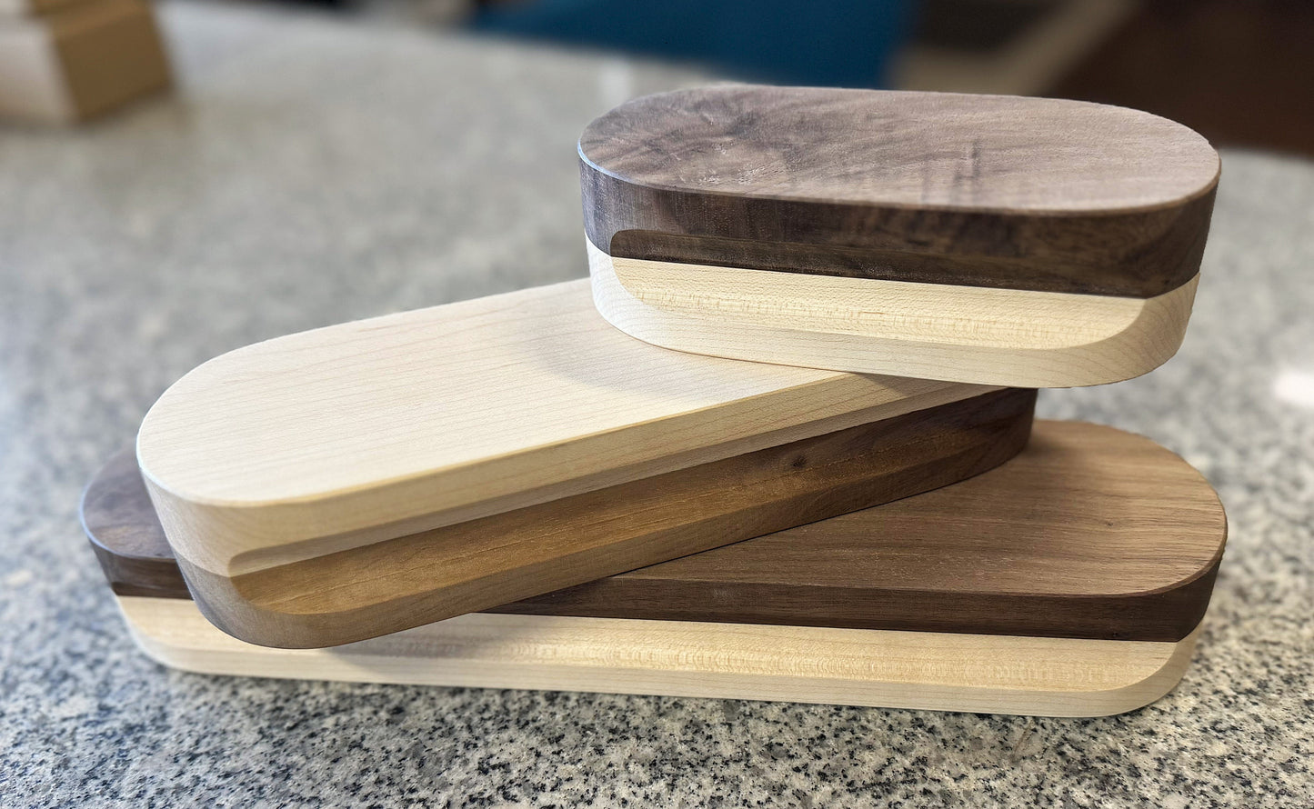 This picture features three quilt clappers, each is staggered and stacked on top of the previous one. Each clapper is a different size with the largest (12") on bottom, medium (9") in the middle and the smallest (6") at the top.